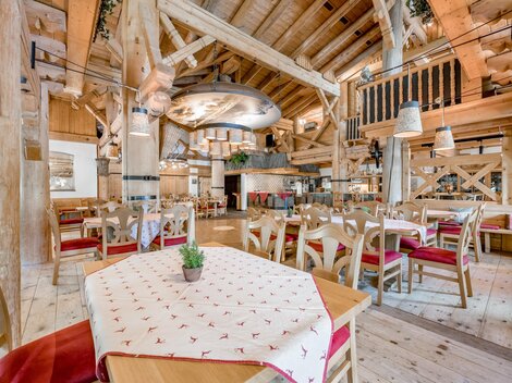A rustic restaurant with wooden decor and cozy tables. The warm colors and inviting atmosphere create a pleasant place to eat.