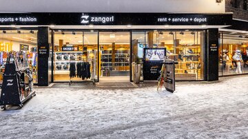 A store with sports and leisure clothing. The entrance area is welcoming and the surroundings are covered in snow.