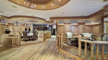 A stylish interior with wood paneling and elegant furniture. The room is bright and inviting, ideal for social gatherings.