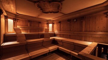 A cozy sauna room with wooden paneling and benches. The warm light creates a relaxing atmosphere.