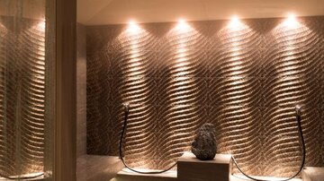 An elegant wellness area with softly illuminated, textured wall design. The atmosphere is soothing and inviting.