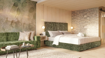 A modern room with a cozy bed and an elegant seating area. The walls are designed with wood and stone, creating a warm atmosphere.