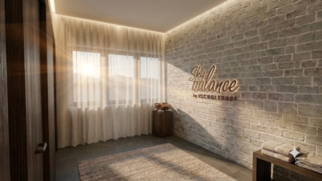 A modern room with a brick wall and large windows that let in light. On the wall, the word "Sky Balance" is displayed in elegant font.