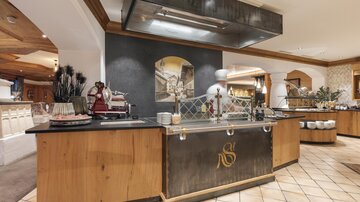 An elegant kitchen with wood and stone elements. The space is well-lit and offers an inviting atmosphere.